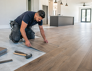 Professional flooring contractor installing luxury vinyl flooring